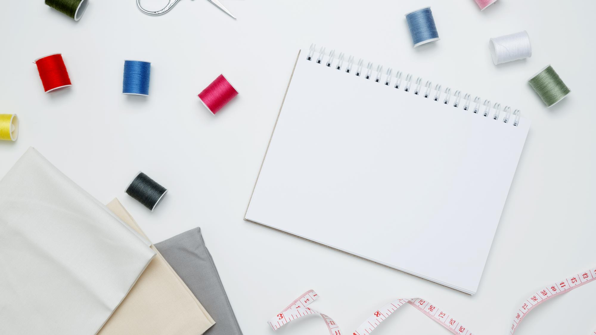 Workspace with threads and hand-embroidered sample